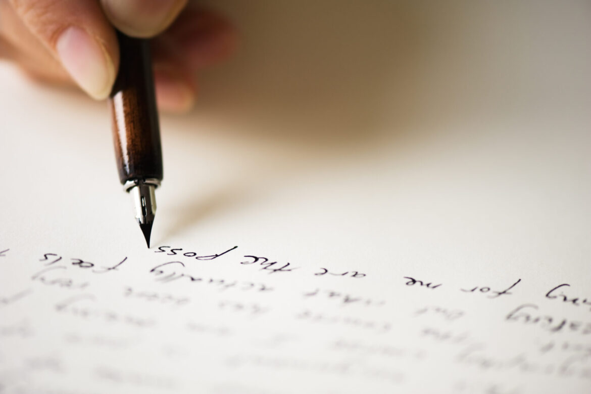 Close up of pen writing a letter