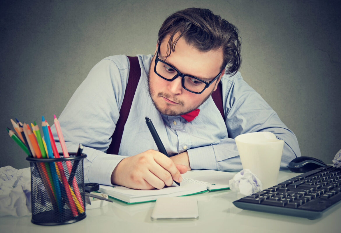 business man making notes in his pad